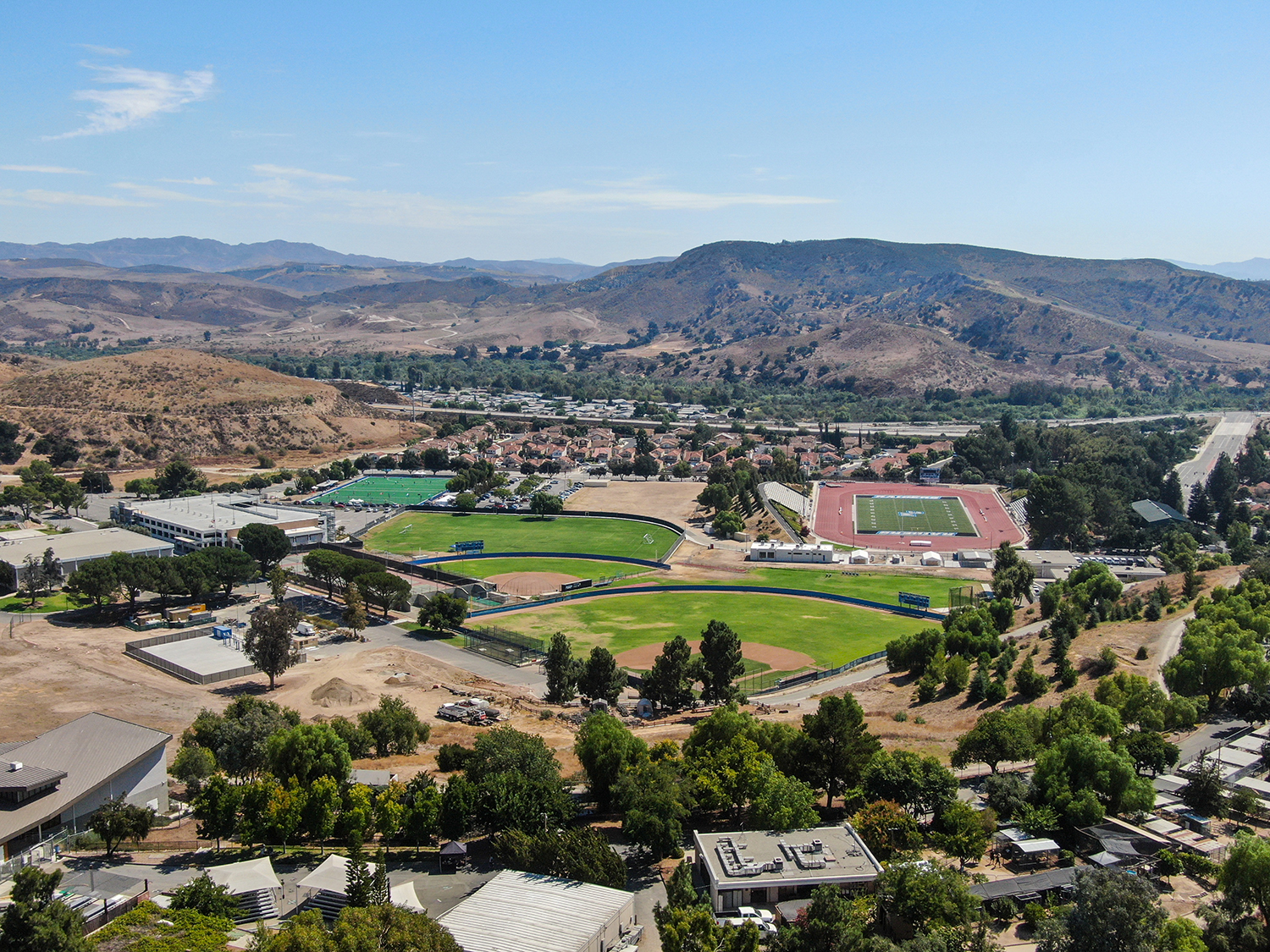 An aerial view of a soccer field and mountains.